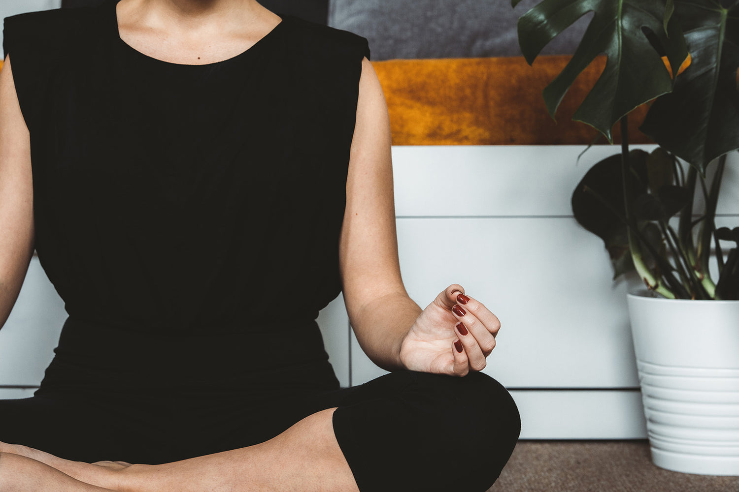 woman sits in cross legged meditation pose