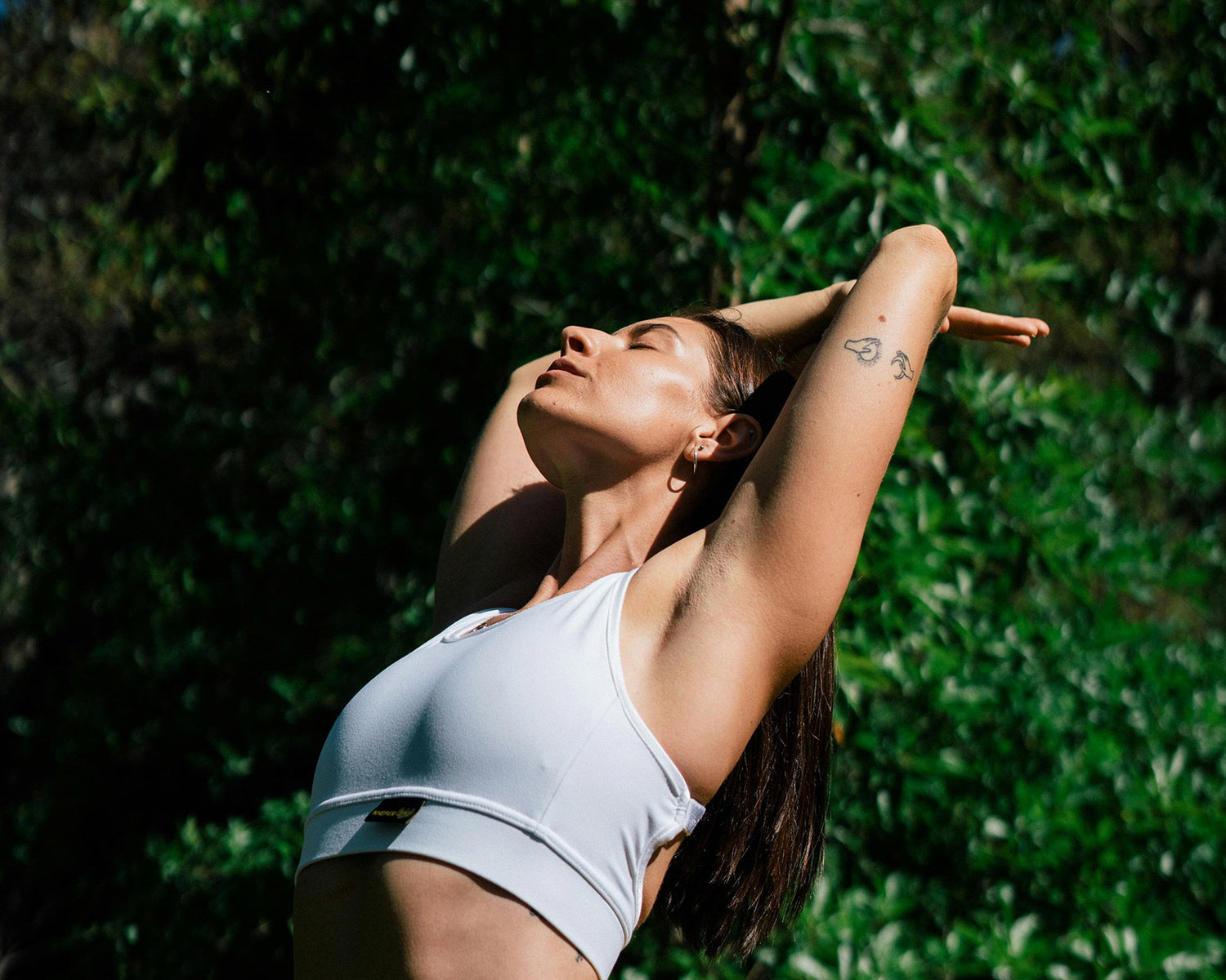 woman stretching back into a yoga pose